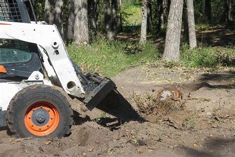 digging ditch with skid steer|skid steer bucket digging.